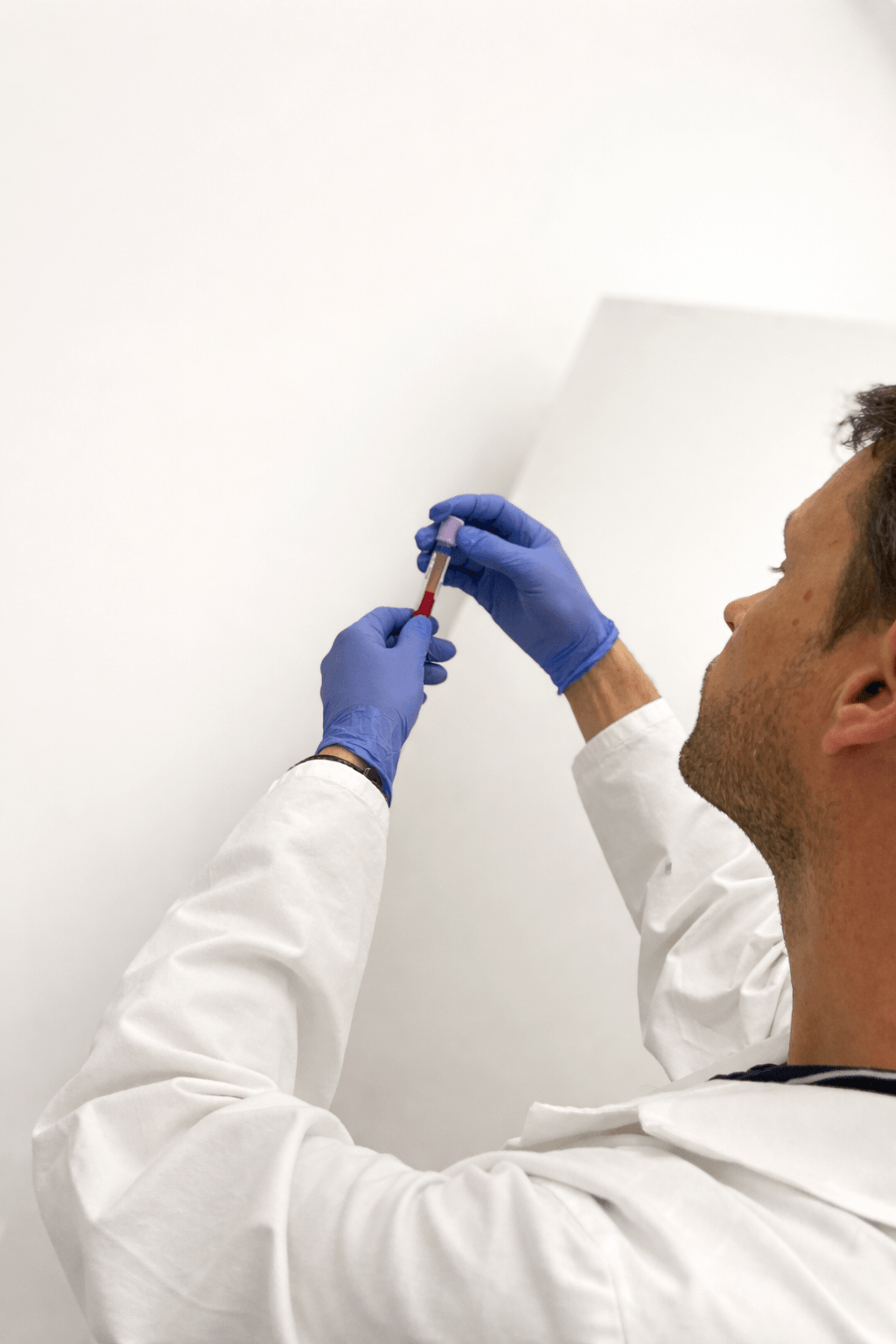 Laboratory technician pipetting samples at Atlas Biolabs